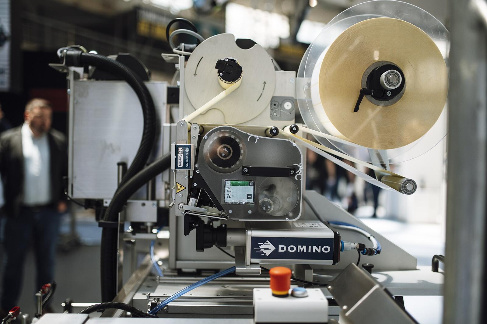 A label printing and coding machine running on a production line